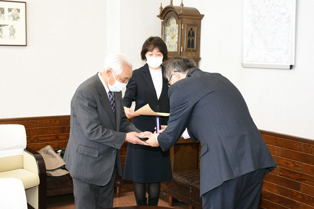 勲記などを受ける則子さんと定吉さん